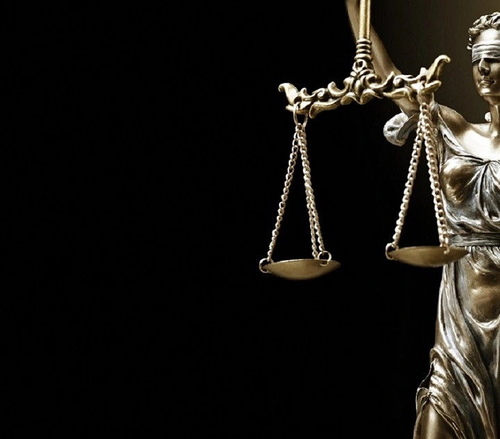 Lady Justice holdings a balance of equities scale